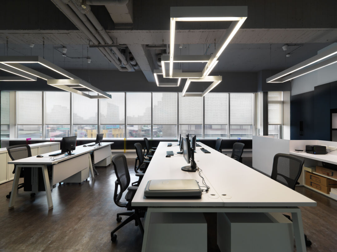 Modern workspace featuring transparent materials and lighting.
