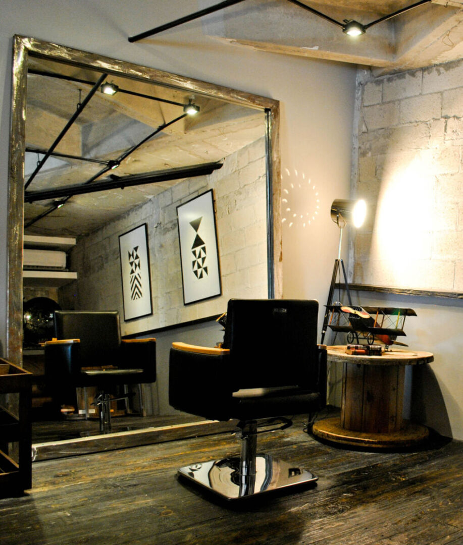 Vertical gray brick wall dividing salon spaces.