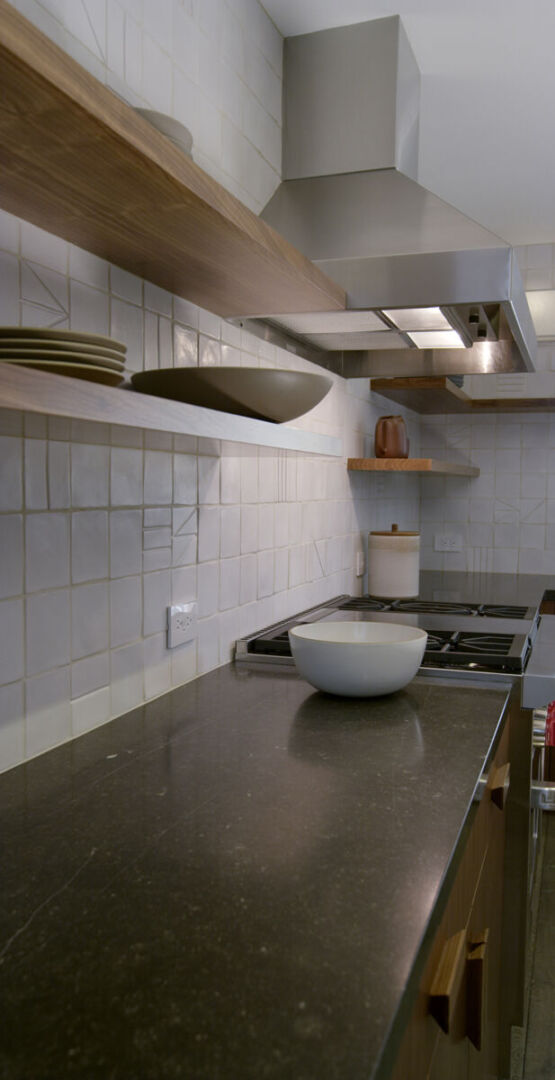 Beautiful kitchen with ceramic backsplash by Heath Ceramics.