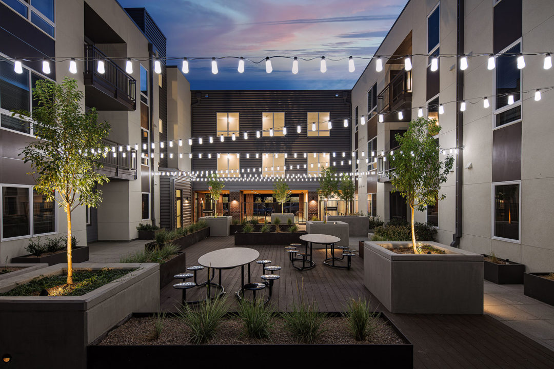 Landscaped courtyard featuring playground and seating areas. Landscaped courtyard featuring playground and seating areas.