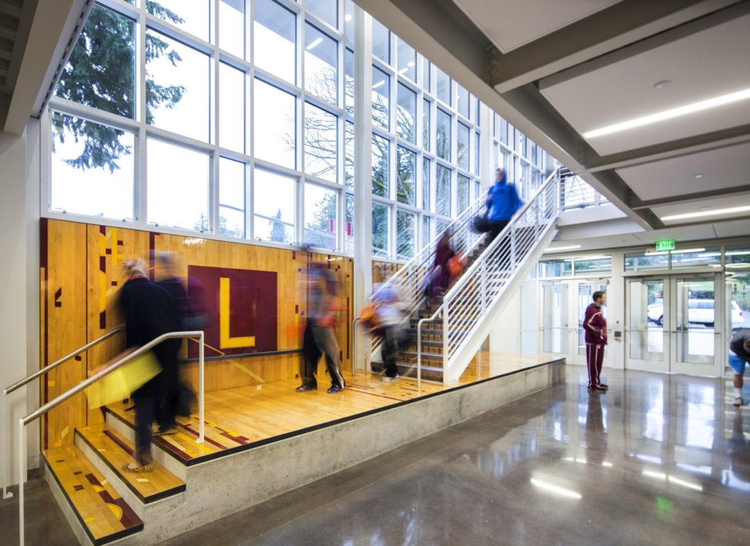 Repurposed wood floors foster camaraderie in the athletic hub. Repurposed wood floors foster camaraderie in the athletic hub.