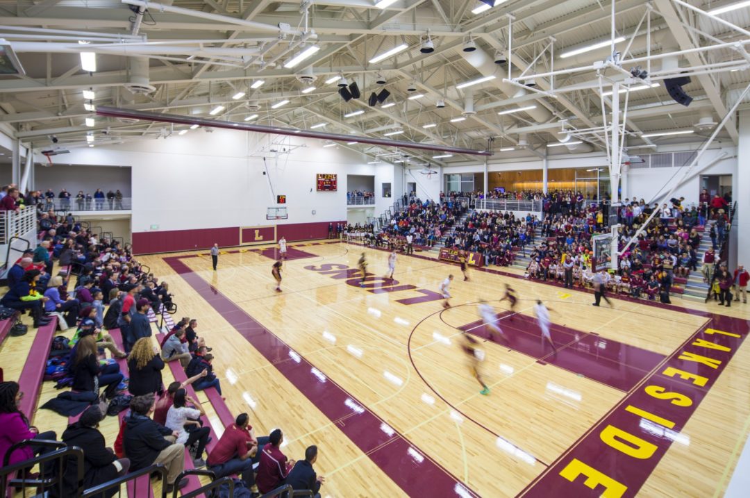 Glass-enclosed circulation connects athletic fields and parking area. Glass-enclosed circulation connects athletic fields and parking area.