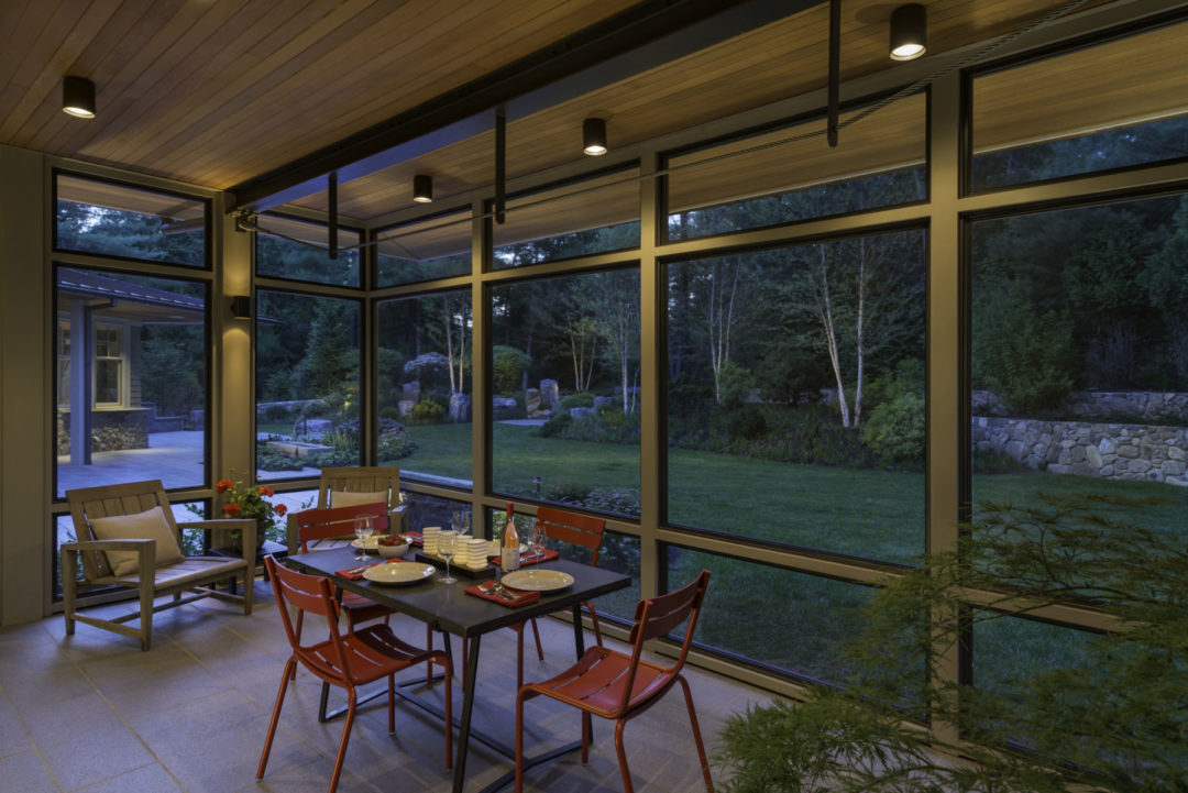Seamless grey granite flooring connects interior and garden.