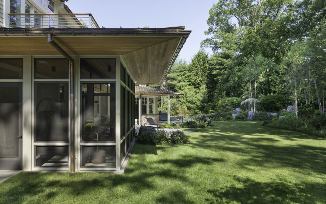 Stunning porch design with extended red cedar overhangs.
