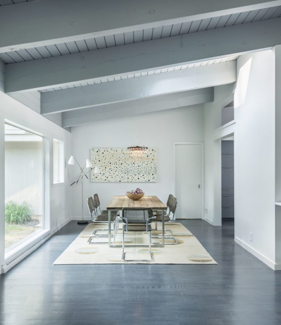 Open floor plan showcasing natural light and wooden beams. Open floor plan showcasing natural light and wooden beams.