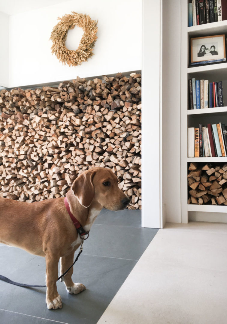 Functional mudroom that doubles as wood storage.